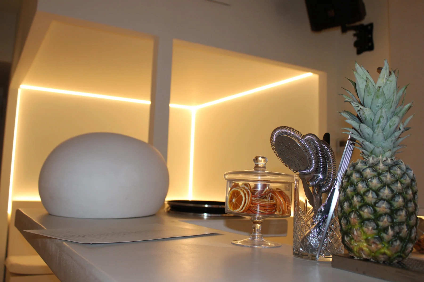 Elegant illuminated cocktail bar detail with pineapple